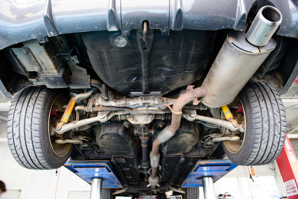 リフトアップされた車の排気管と足回り
