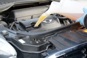 メルセデス・ベンツのエンジンにエンジンオイルを注入する手元